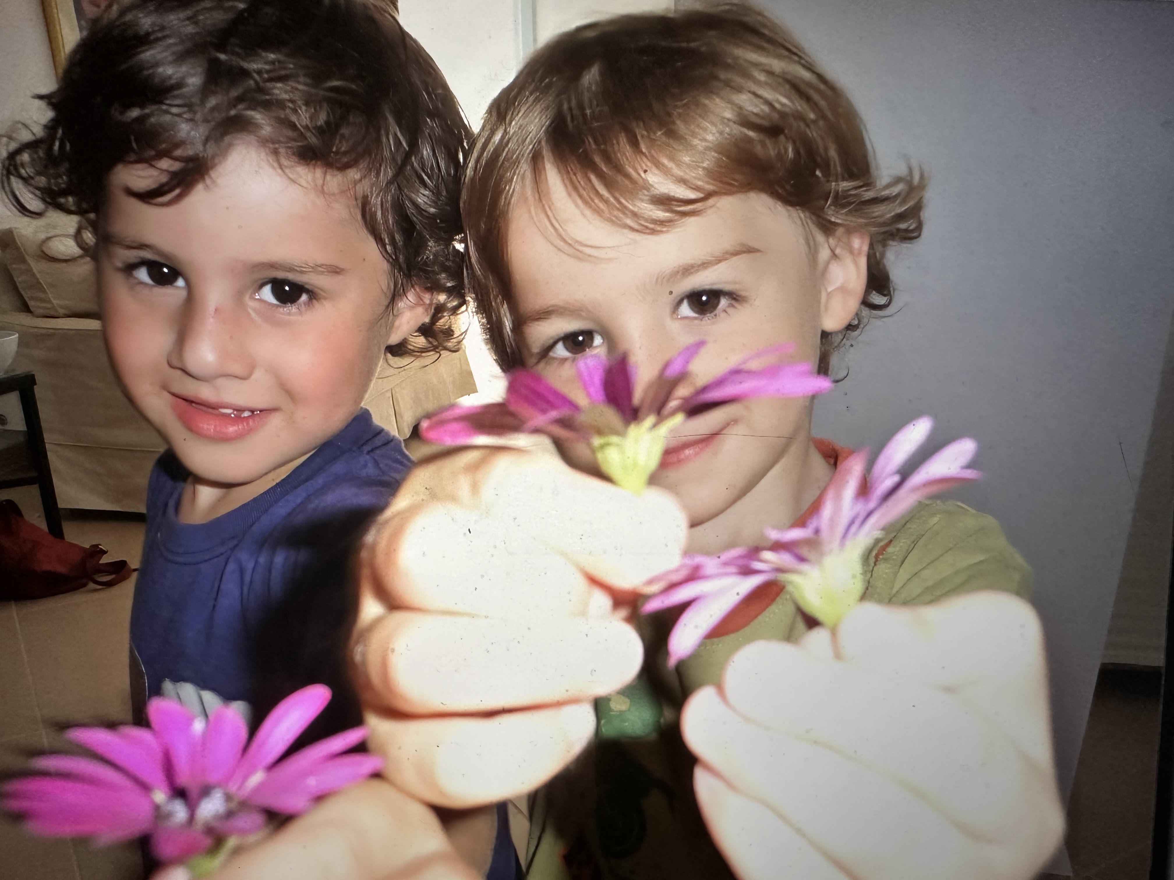 Connall and his brother presenting flowers for their mum