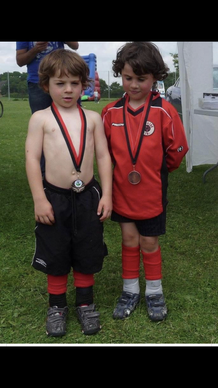 Young Connall and brother with football medals