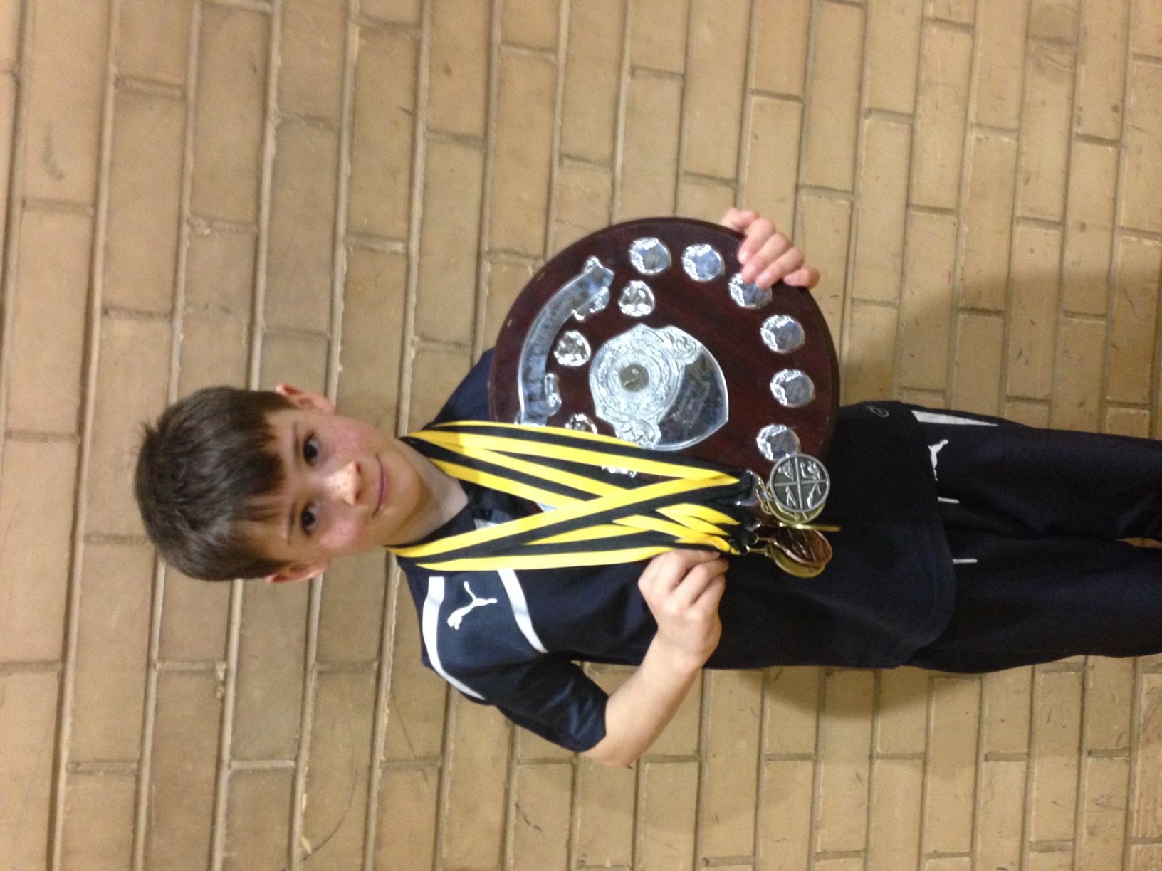 Young Connall with swimming shield and medals